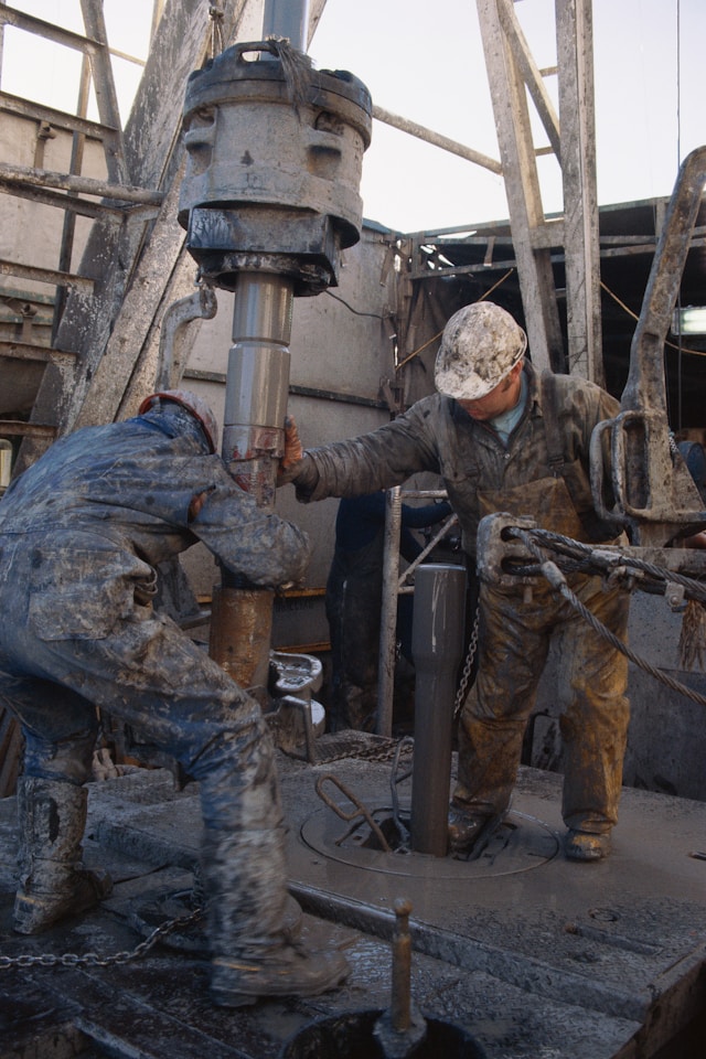 Industrial Worker Dressed In Red Uniform Working On Gauges